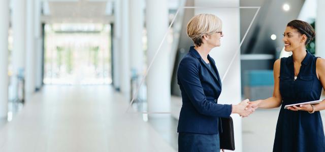 Two Business Women Shaking Hands